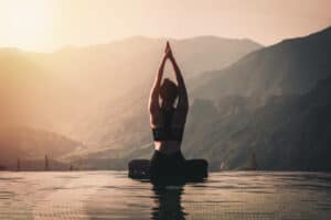 Beautiful Attractive Asian woman practice yoga Lotus pose on the pool above the Mountain peak in the morning in front of beautiful nature views,Feel so comfortable and relax in holiday,Warm tone. Frustrated young woman suffering from the headache while sitting on the sofa at home. How to Handle Stressful Situations Instead of Living in Hope Of a Cure