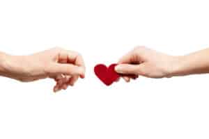 Female hand gives a male heart. Give love, a pair of lovers. Organ donor. My heart, holding my heart. What Matters Most is On the Inside
