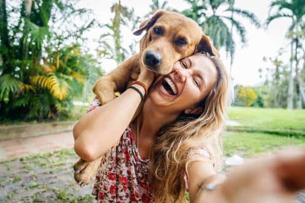 A happy Latin woman enjoys spending time with her dog outdoors in a Viletta countryside home in Colombia. Love Yourself As You Would Your Neighbor