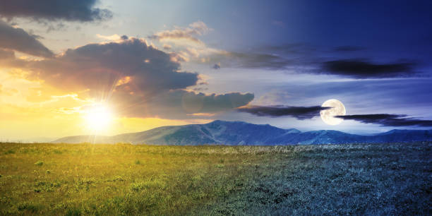 day and night time change concept above alpine mountain meadow in summer. beautiful landscape of carpathians with sun and moon on the sky. Choosing Between Night and Day