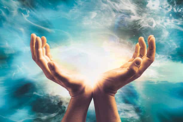 Close up of conceptual hand sending cosmic healing energy to universe. The Three Forces that Will Make you Happy and Healthy