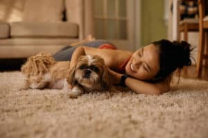 Happy Asian woman and her Shih Tzu dog relaxing on the floor at home. Uncover Emotional Secrets And Live A Happier Life
