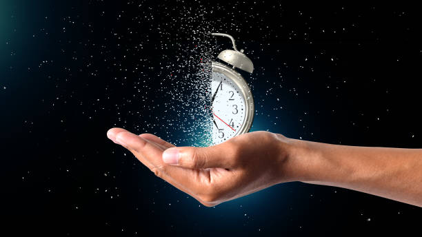 Symbolizing the passage of time, an analog clock fractures, held in a hand with a dispersion effect. This image encapsulates the essence of 