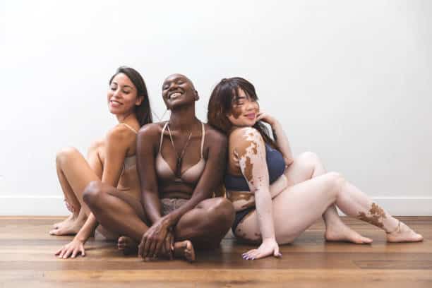 Body positivity - women friends posing at home in lingerie