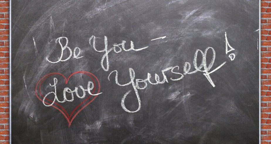 Love yourself wriitten on chalk board
